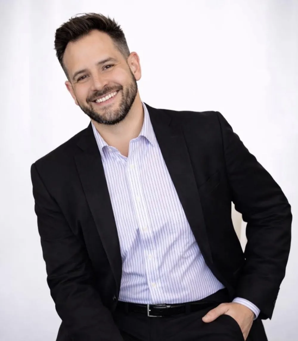 Andrew Gear, MK Alliance Group team member, in a black blazer